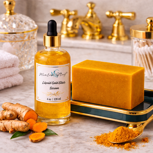 Glass dropper bottle labeled “Liquid Gold Elixir Serum” placed beside a golden turmeric soap bar on a decorative tray, with fresh turmeric root and ground turmeric powder on a marble countertop and gold bathroom fixtures in the background.